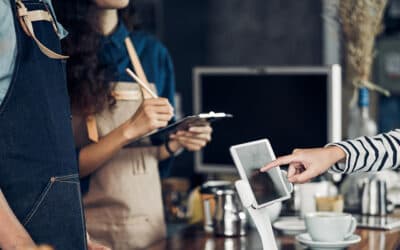 People taking an order in a coffee shop using a tablet